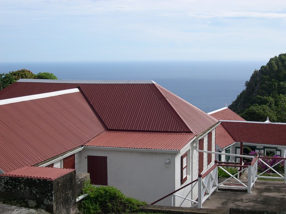 red metal roof installation on sea-side home