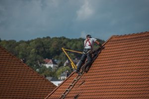 roofers repairing roof